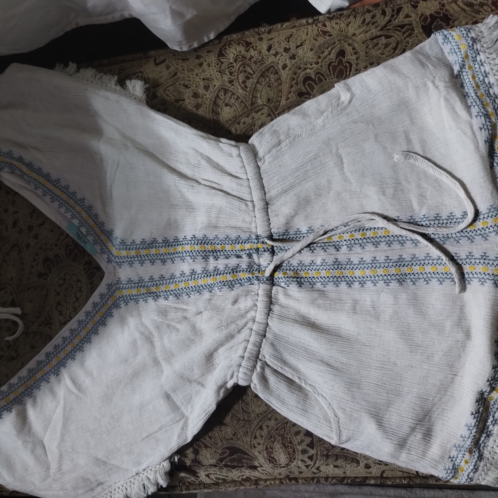 Karlie Cream Colored Romper With Blue And Yellow Embroidered Accents.
